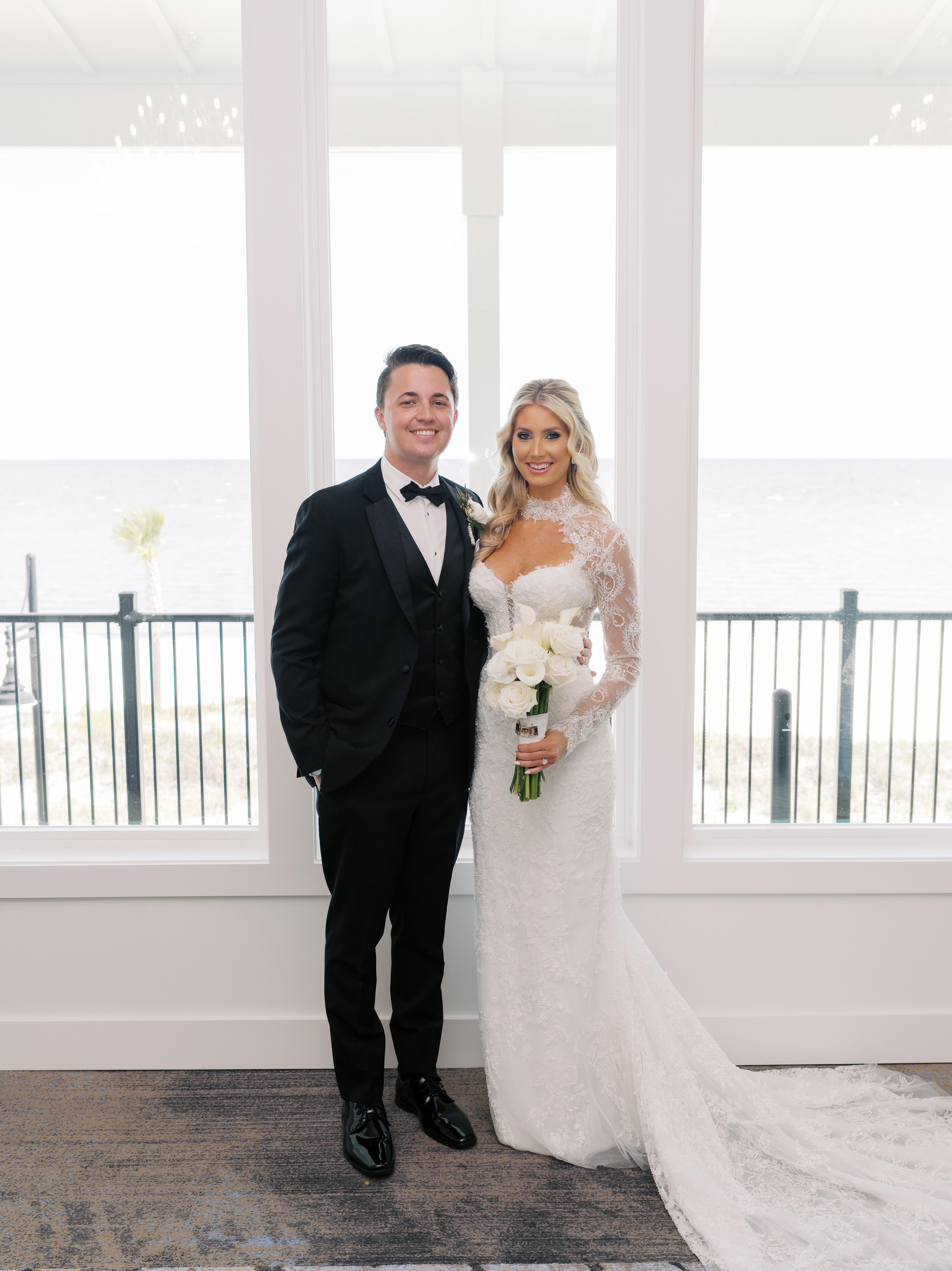 Bride and groom by the window with ocean views