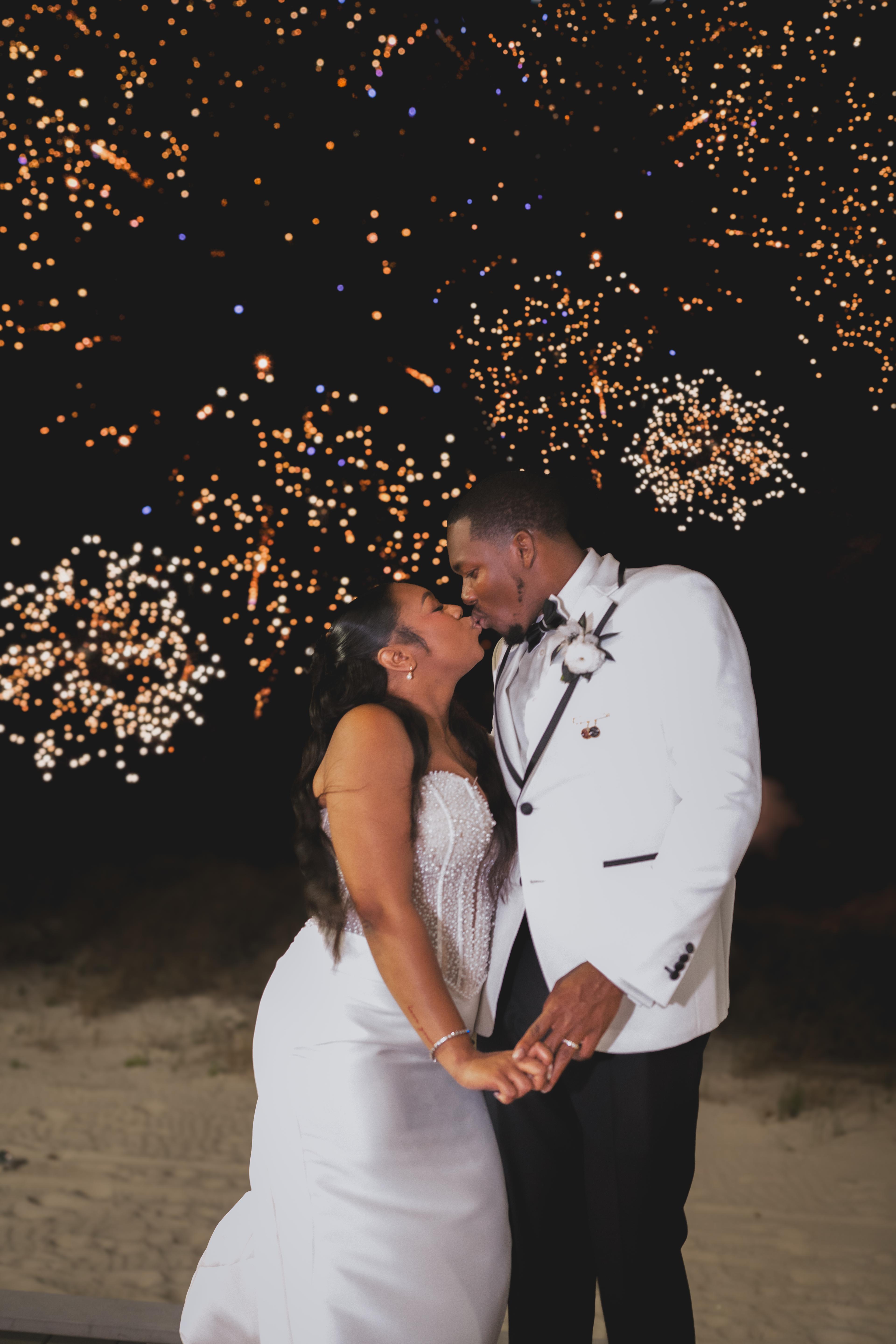 Bride and groom celebrating with fireworks